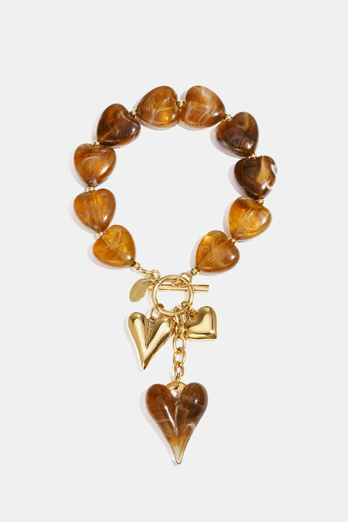 Beaded bracelet with hanging heart charms
